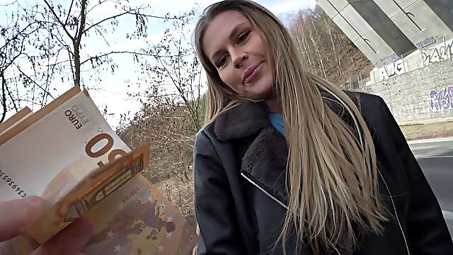 Guy and girl have fun in his car.