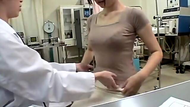 Busty Jap gets a dildo up her twat during medical exam
