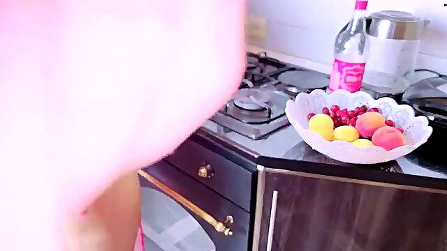 Older sexually excited woman has sex in the kitchen with her stepson during the time that her spouse is watching TV