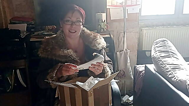 A milf sucks off a fan in front of one of her porn movies