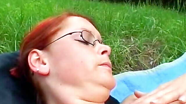 Redhead slut from Germany gets her pussy dildoed outdoors
