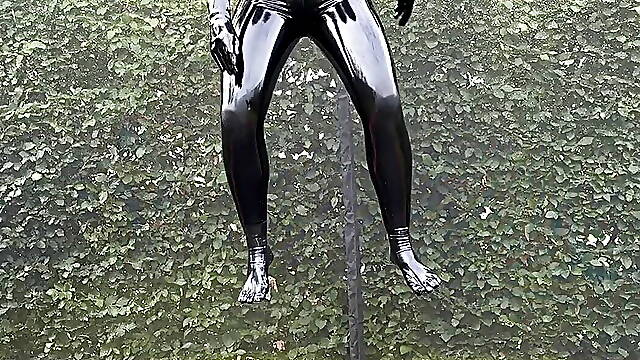 Miss Fetilicious jumping in latex catsuit