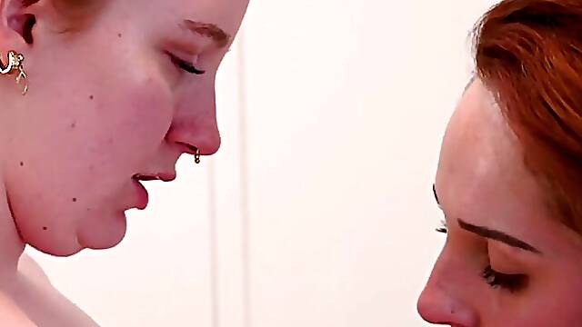 Horny redheads lick and finger each other on bed